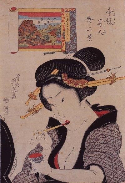 Japanese woodblock print of a woman painting her lips in red
