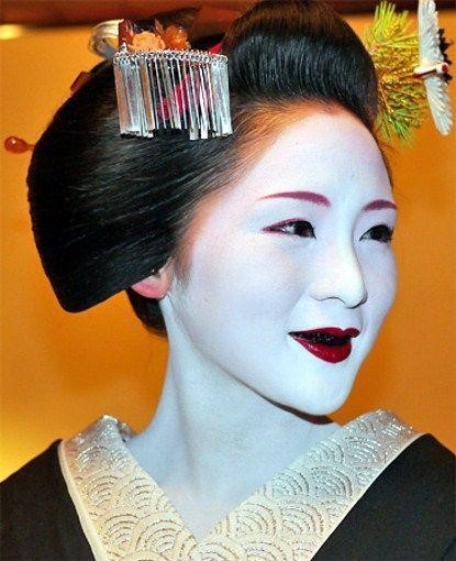A Japanese geisha with her teeth painted black