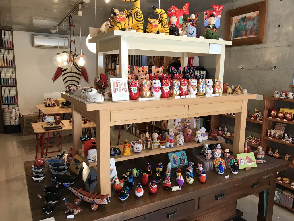 Lots of  colorful toys displayed on tables and shelves