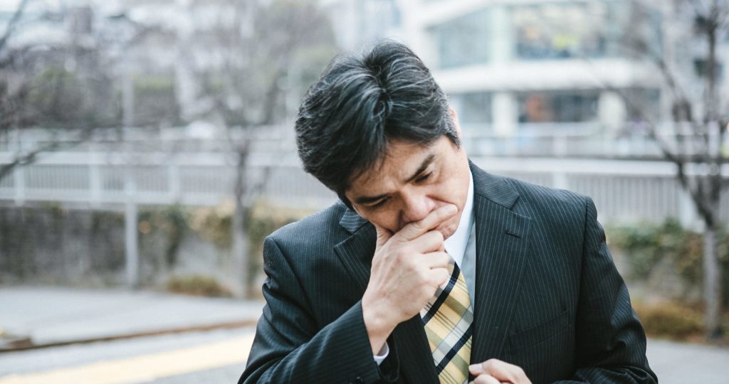 Older Japnese businessman thinking deeply