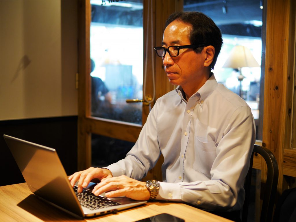 Tetsuo Kumon working on his computer