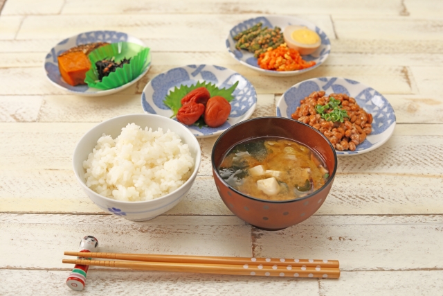 Japanese food on  table. Chopsticks ae laid on a chopsticks rest