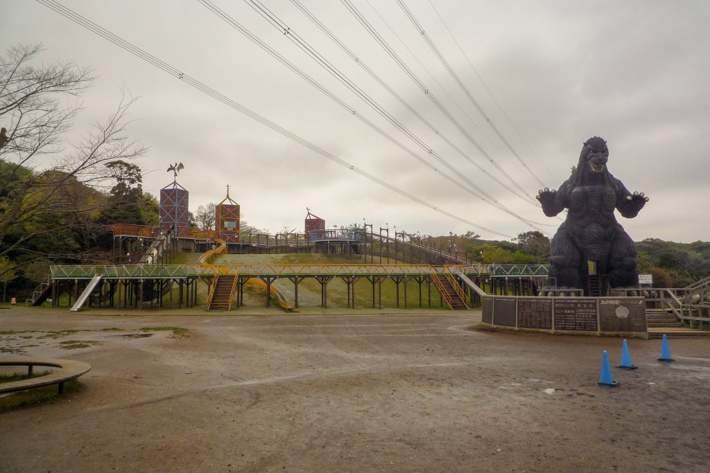 A Godzilla statue in a children's park