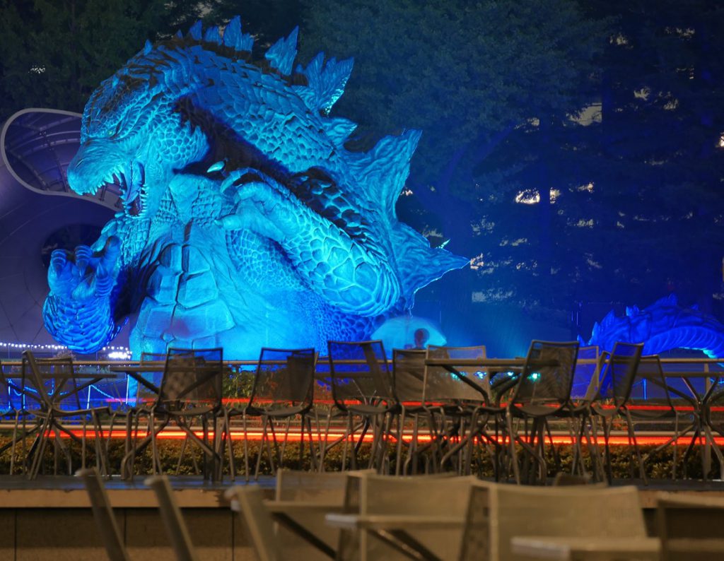 Huge Godzilla statue lighted in blue