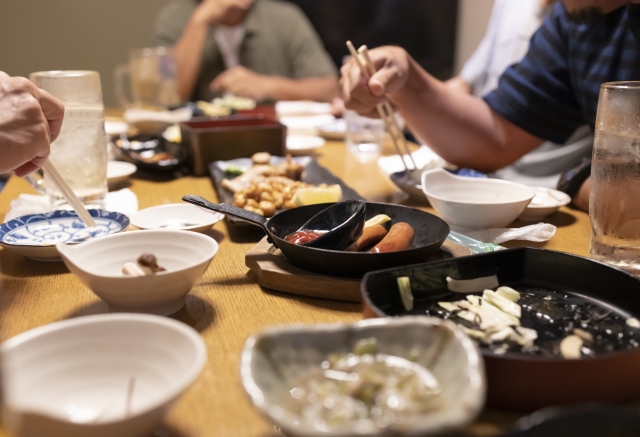 A Japanese tavern table with many shared dishes and small plates