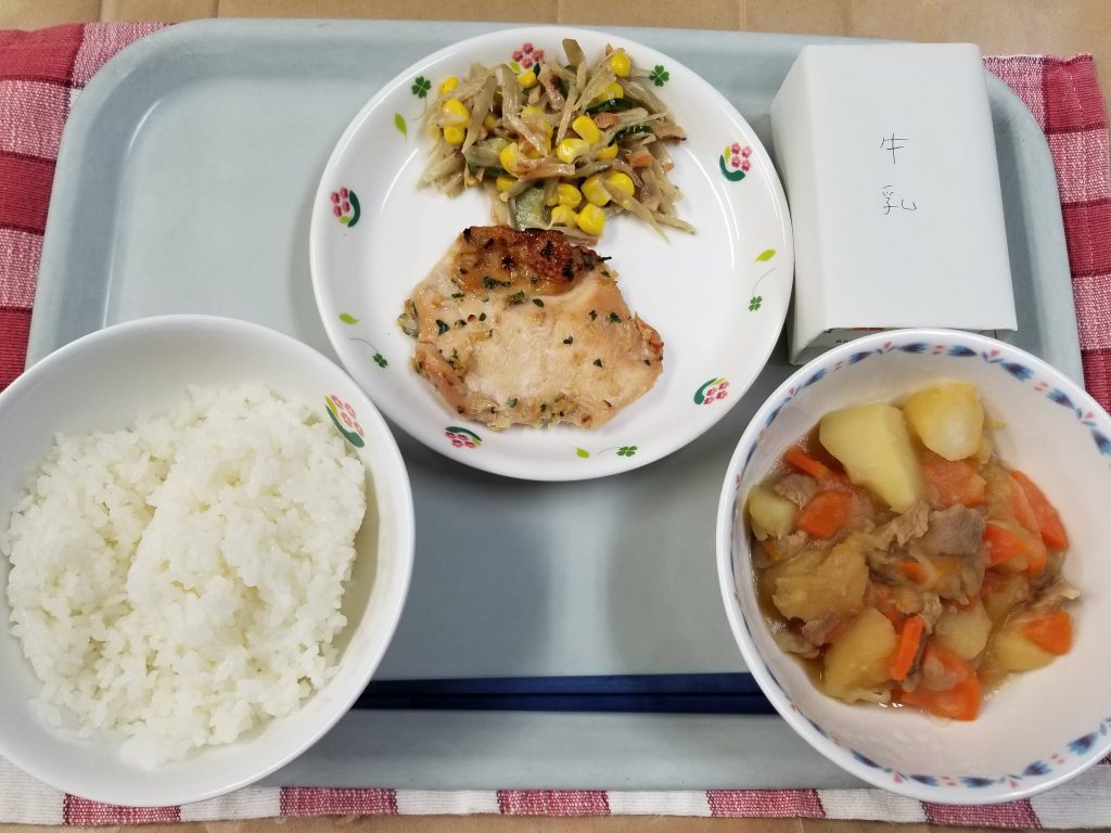 A meal made with rice, meat, vegetables and a soup of vegetables