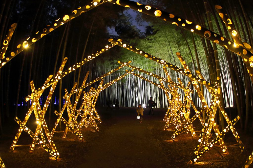 A tunnel made of lighted up carved bamboos