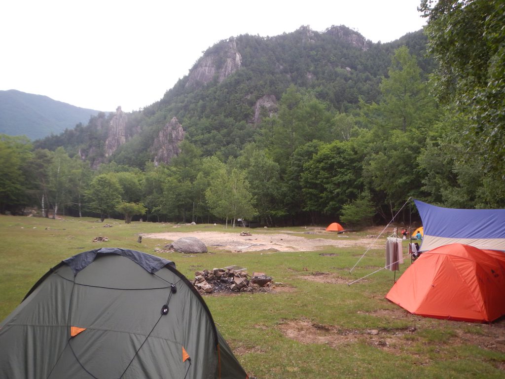 Some tents and the remnants of a camping fire