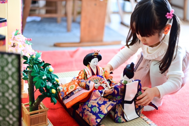 Japanese girls playing with porcelain dolls