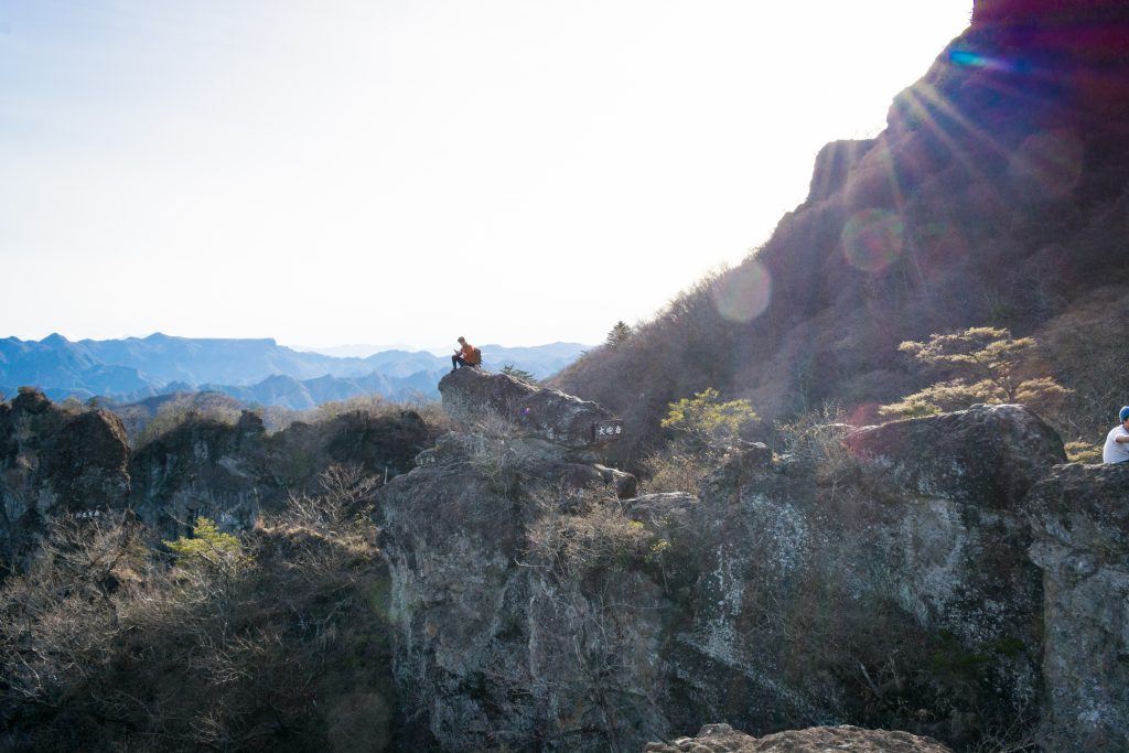 Eli standing far away on a cliff