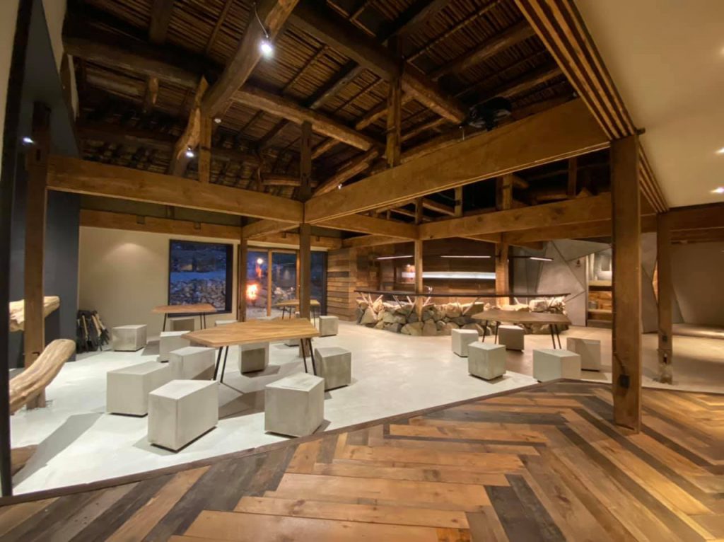 A spacious co-working space mostly made of wood and stone materials