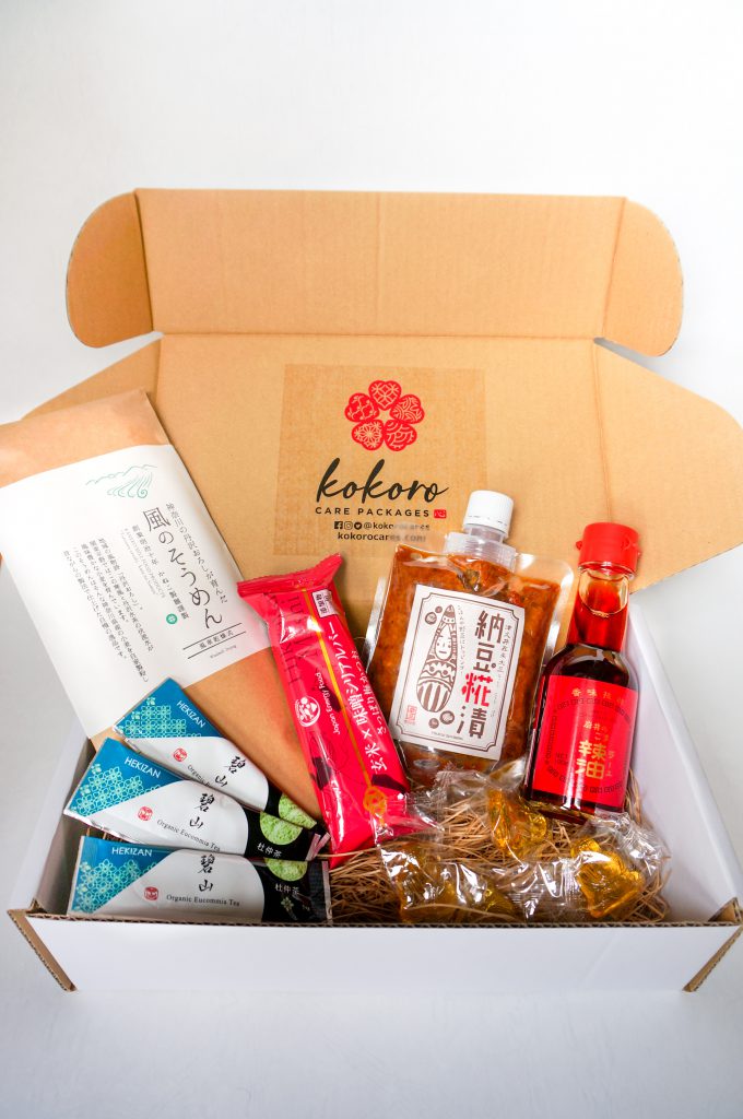 A box containing different sauces, noodles and more.