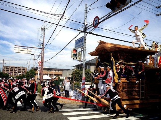 Japanese men are pulling a huge wooden float