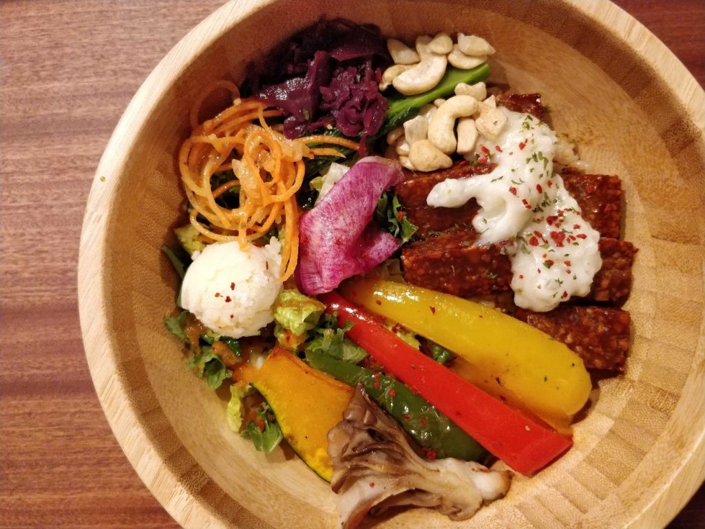 A bowl with nuts and vegetables