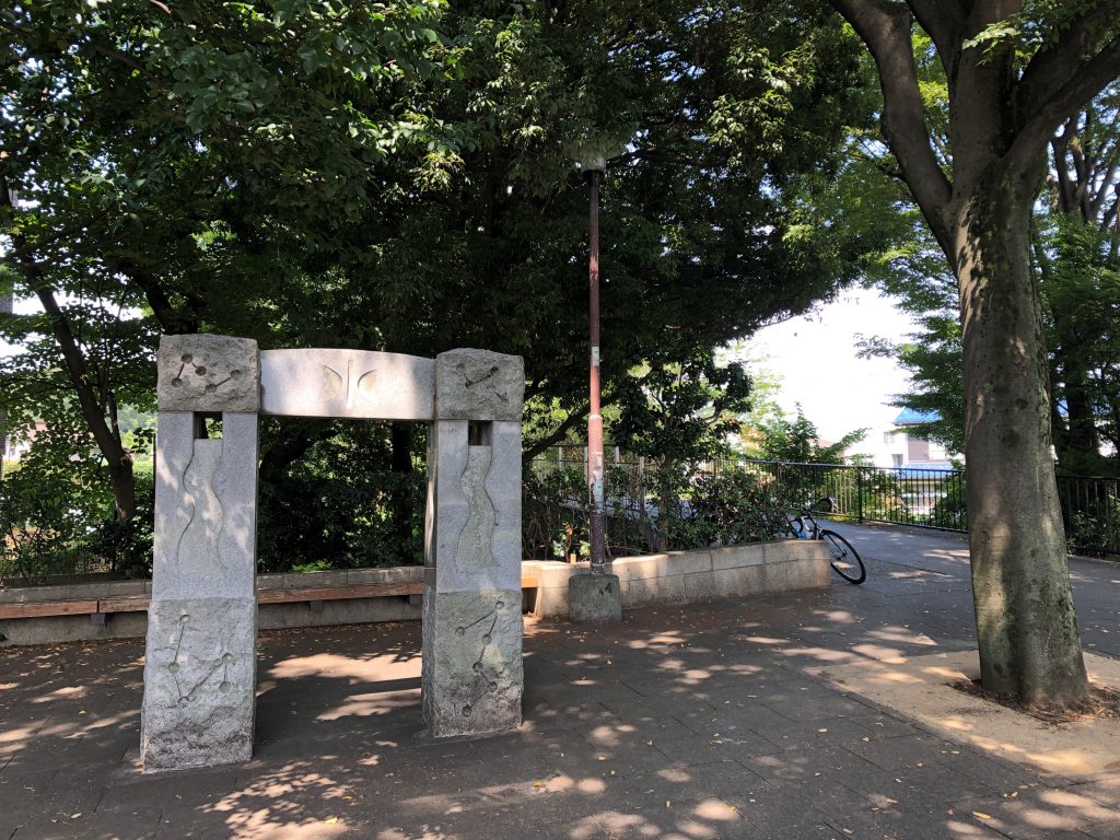 Two small stone pillars mark the entry of the road.