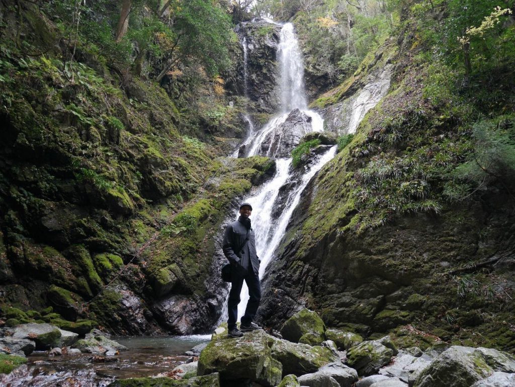 Anthony in front of a waterfall