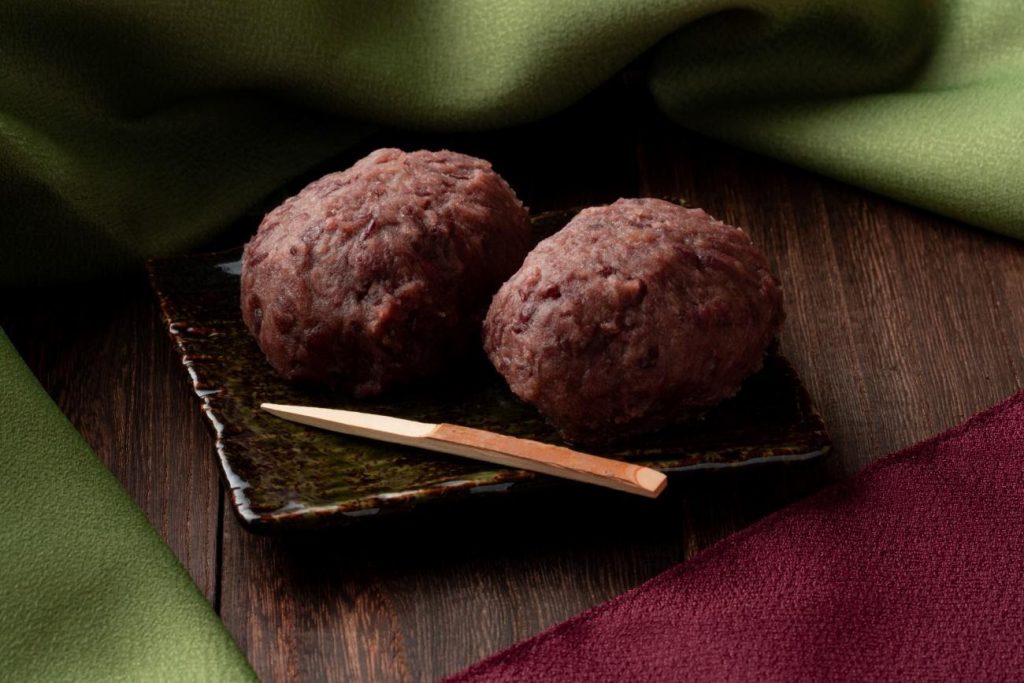 Two Red-brown round cakes on a plate.