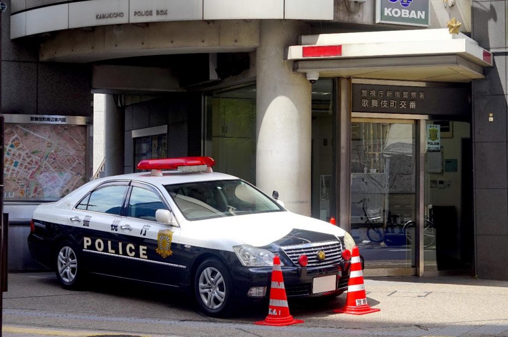 A police car in front of a Japanese police station