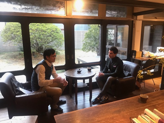 Two men are talking in a nice cafe