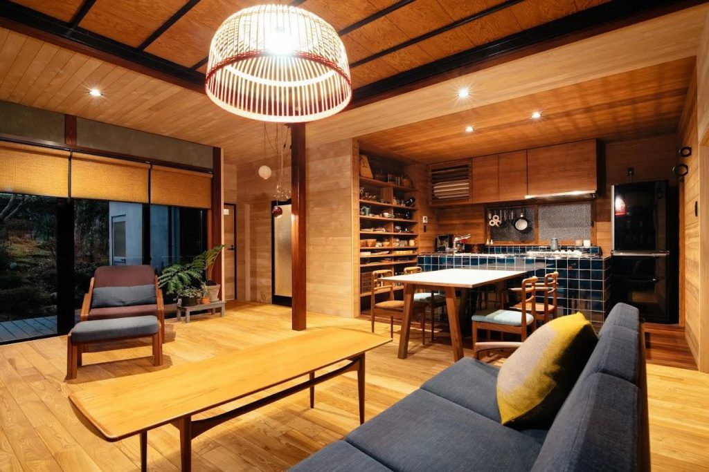 A modern and elegant wooden interior: a living room and a kitchen counter