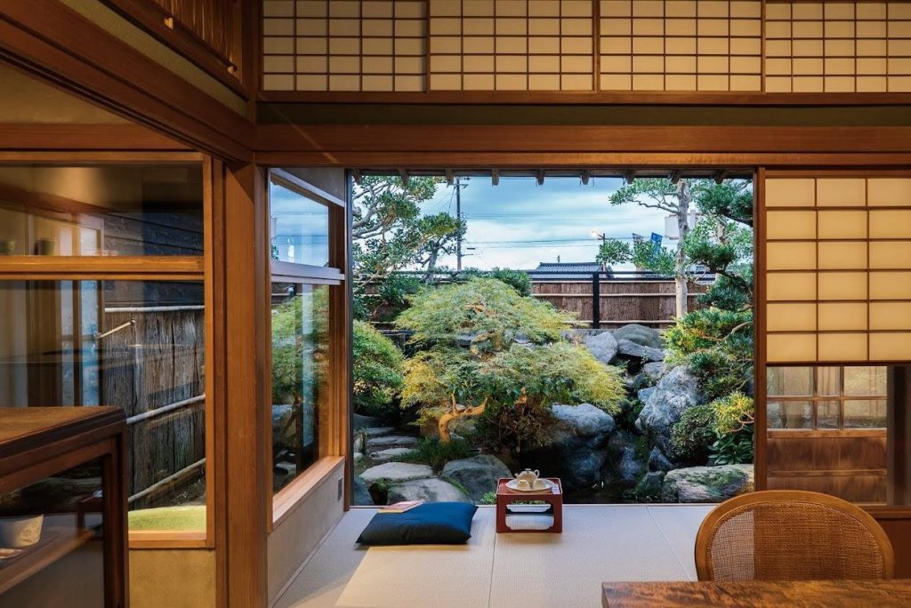 A Japanese-style living room is opened on a Japanese garden.