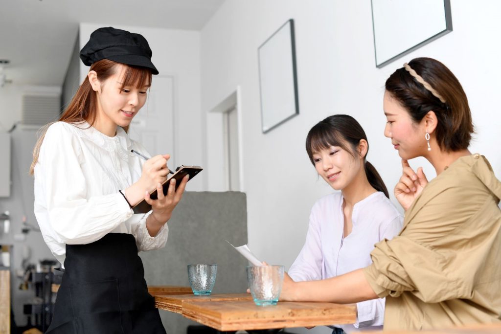 Japanese women are ordering at a restaurant