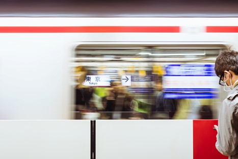 A full train is departing Tokyo station