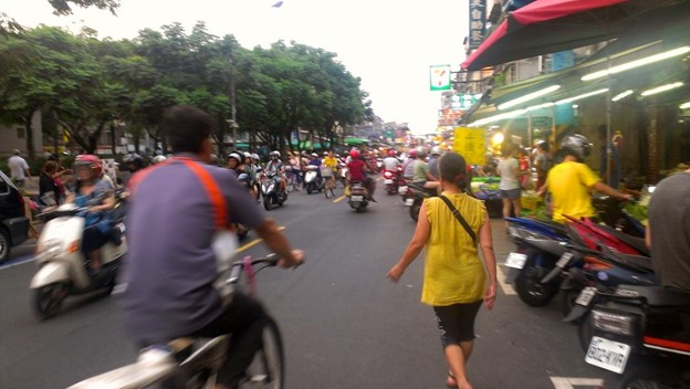 A busy streets with lots of scooter