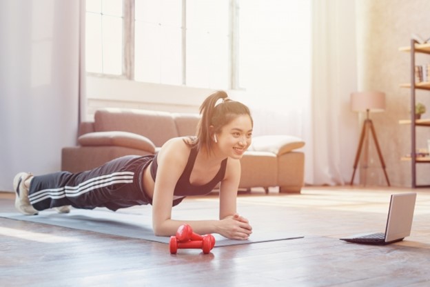 A woman is doing a workout at home