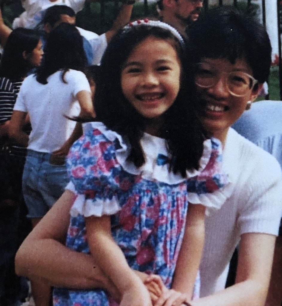 Cynthia Usui hugging her daughter. Both are smiling.