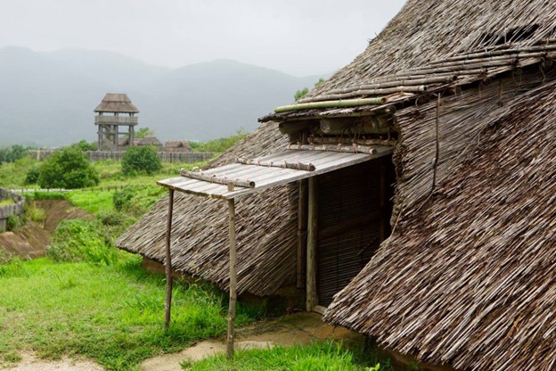 A wooden hut with a thatched roof